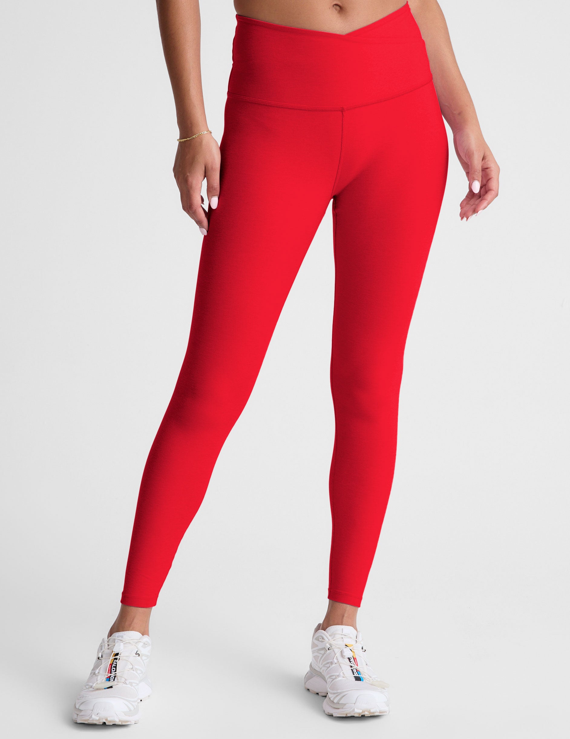 red high-waisted midi legging with criss cross front detail.