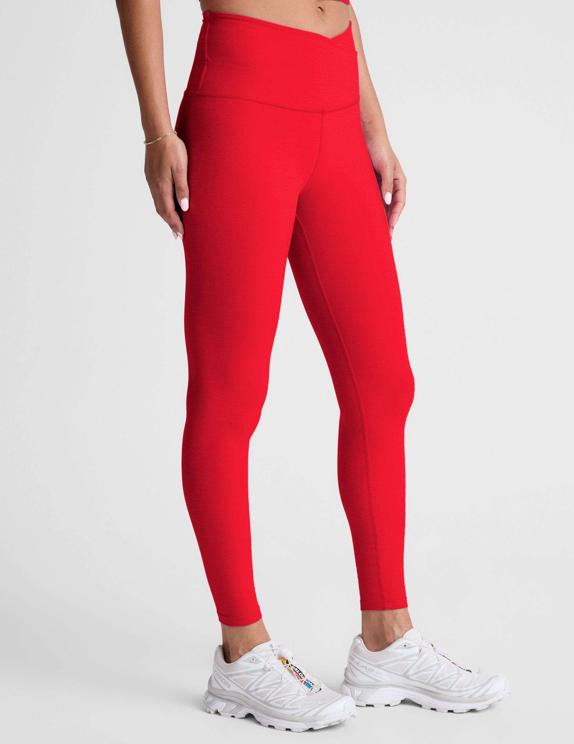 red high-waisted midi legging with criss cross front detail.