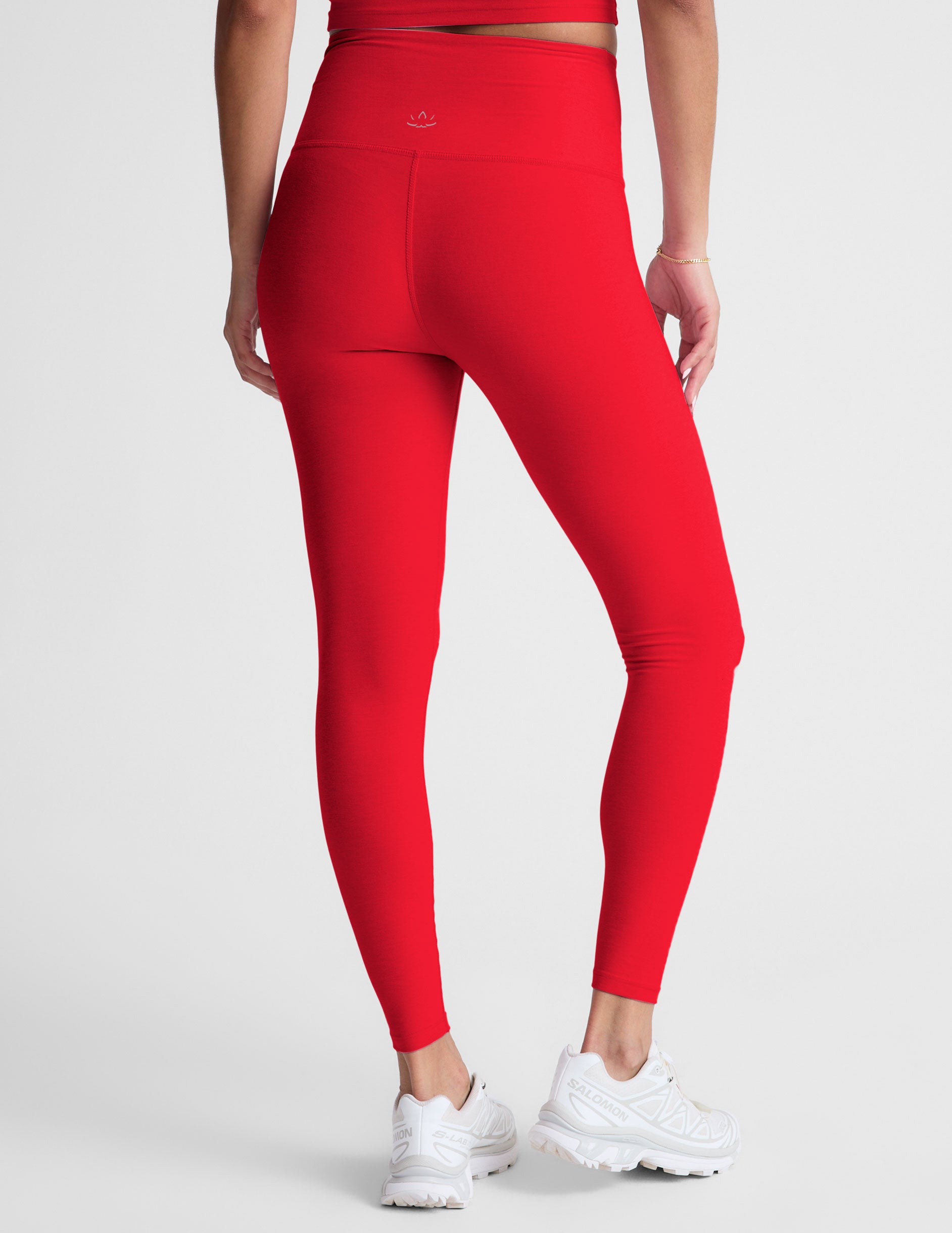 red high-waisted midi legging with criss cross front detail.