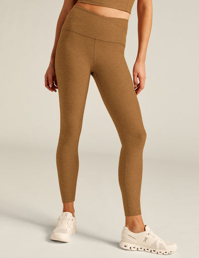brown high-waisted midi leggings with a crossover detail on the front waistband. 