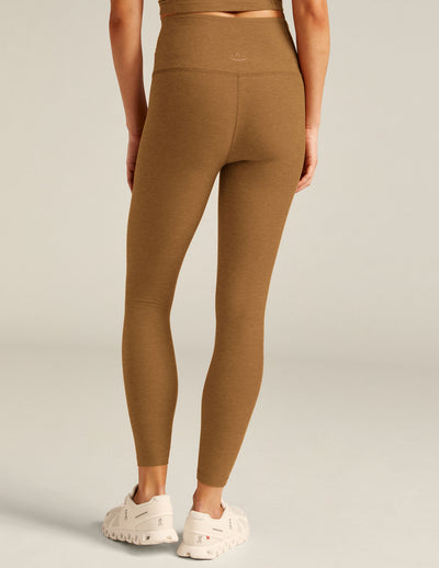 brown high-waisted midi leggings with a crossover detail on the front waistband. 