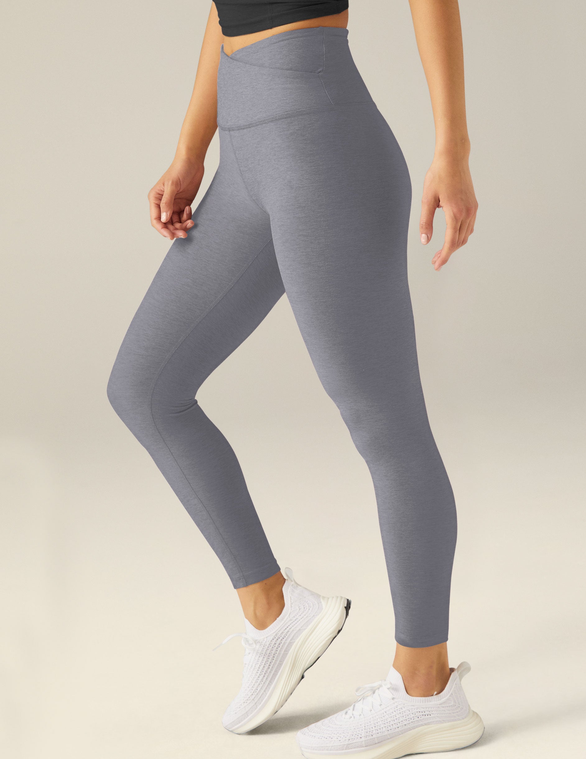 gray high-waisted midi leggings with a crossover detail on the front waistband. 