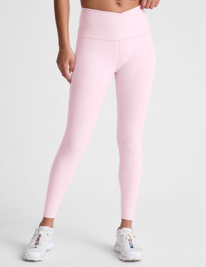 Pink leggings worn by a person on a light gray background