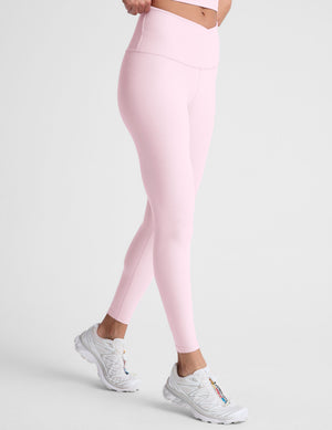 Pink leggings worn by a person on a light gray background
