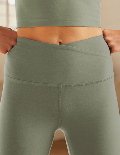 green midi leggings with crossover design on front waistband