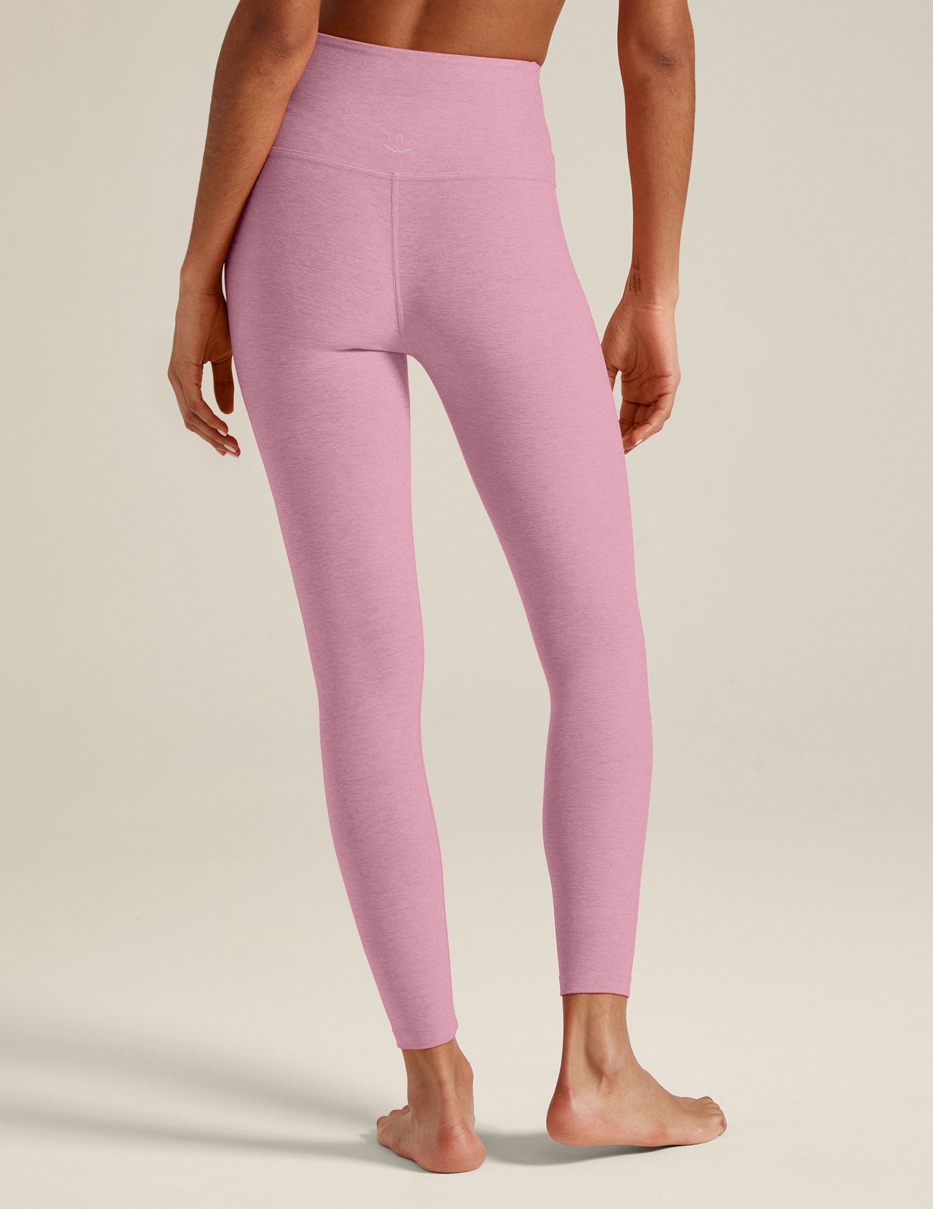 pink high-waisted midi leggings with a crossover detail on the front waistband. 