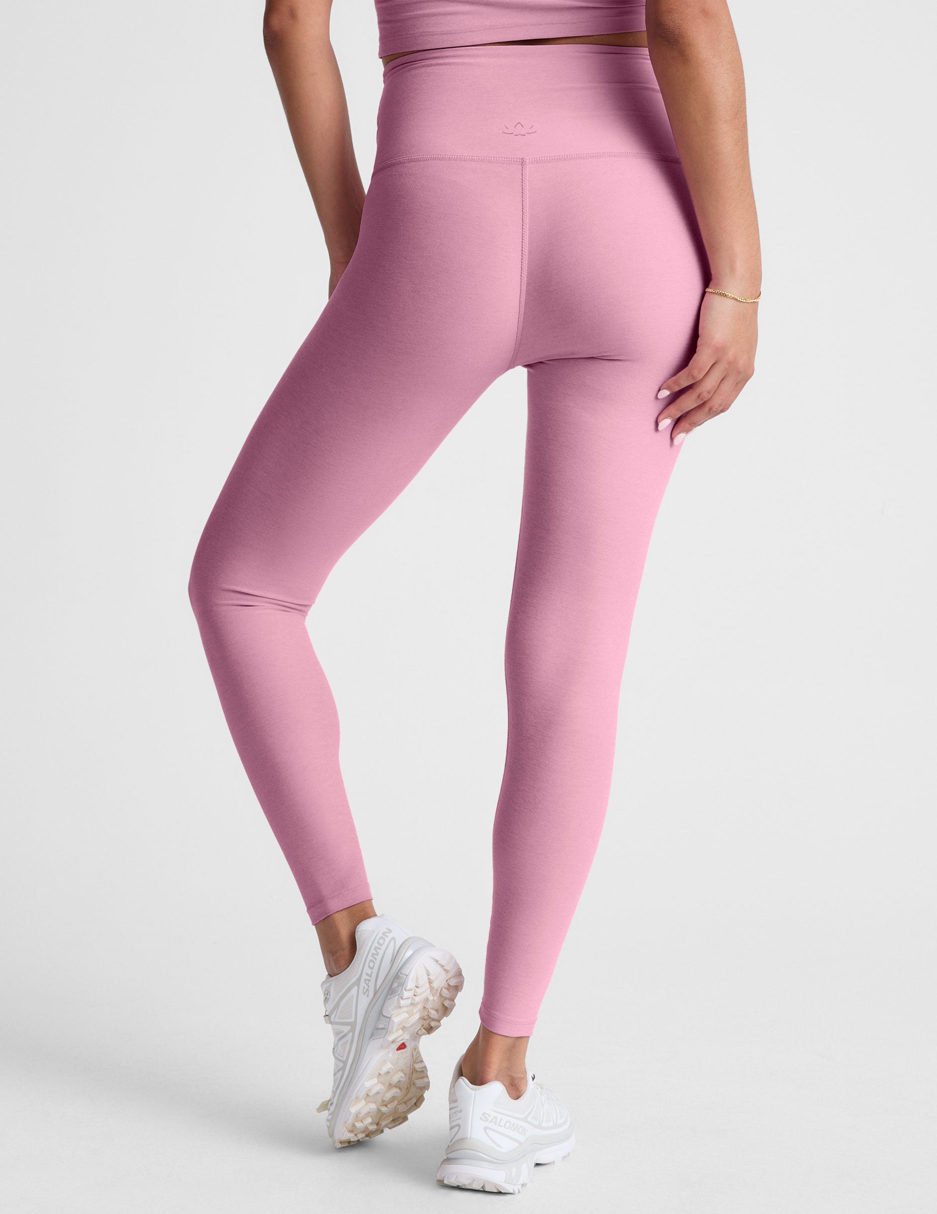 pink high-waisted midi leggings with a crossover detail on the front waistband. 