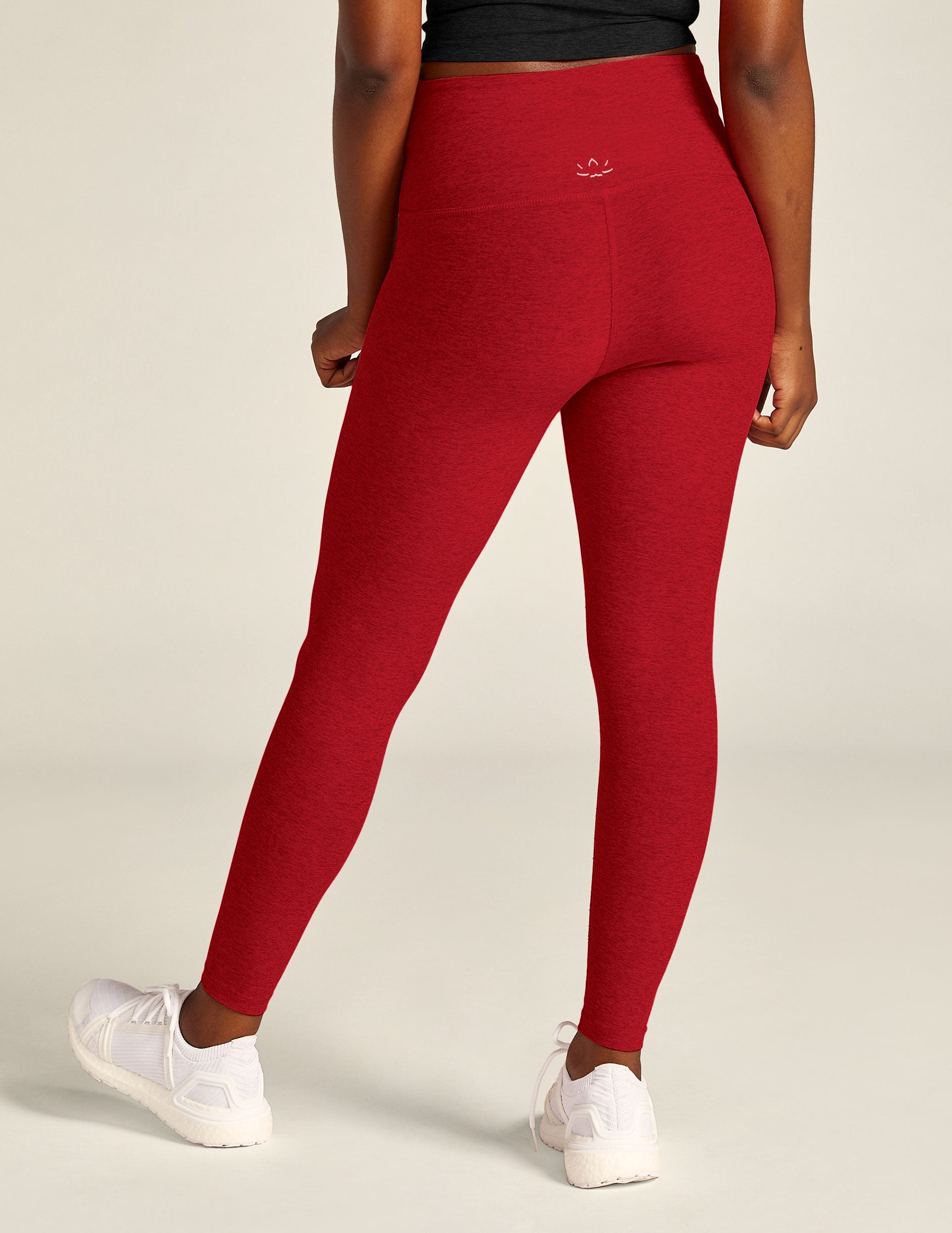 red high-waisted midi length legging with a crossover detail on the front waistband. 