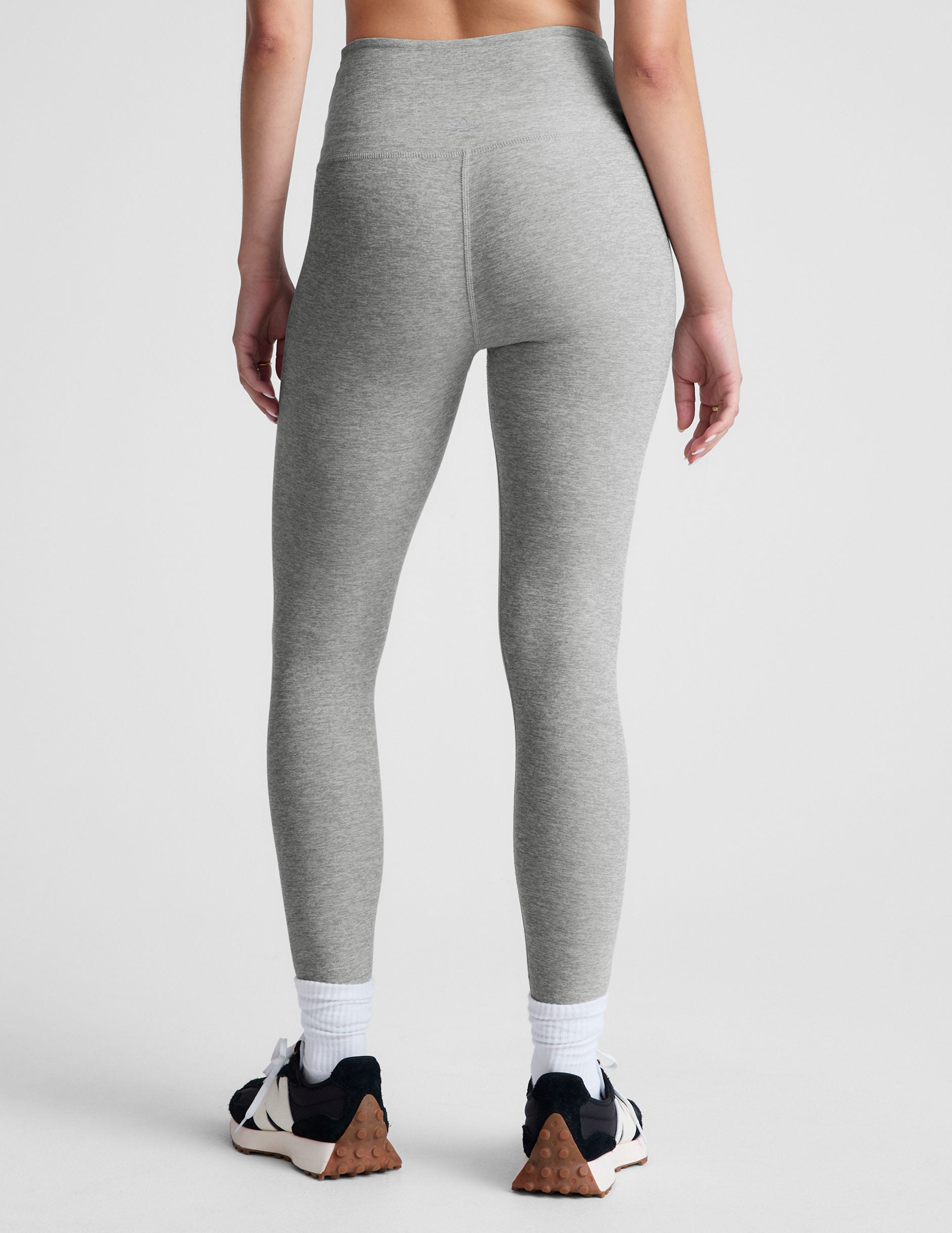 gray high-waisted midi length leggings with a crossover detail on the front waistband. 