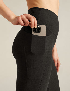 Spacedye High Waisted Pocket Pedal Pusher Legging in black marled fabric with a phone being tucked into the side pocket.