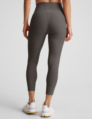 Rear view of a person wearing gray Spacedye Out Of Pocket High Waisted Capri Leggings with a wide waistband and side pocket.