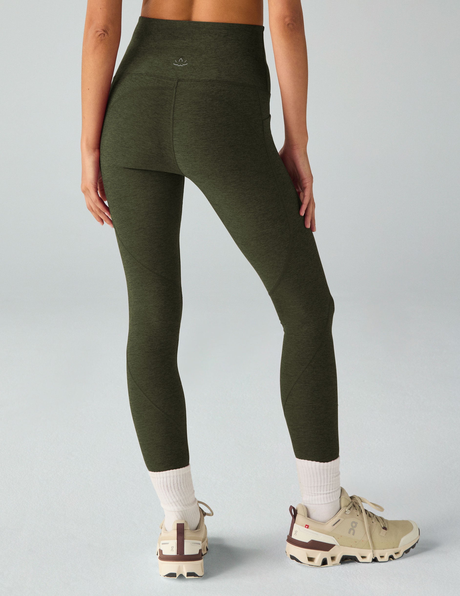 green high-waisted midi leggings with side pockets. 