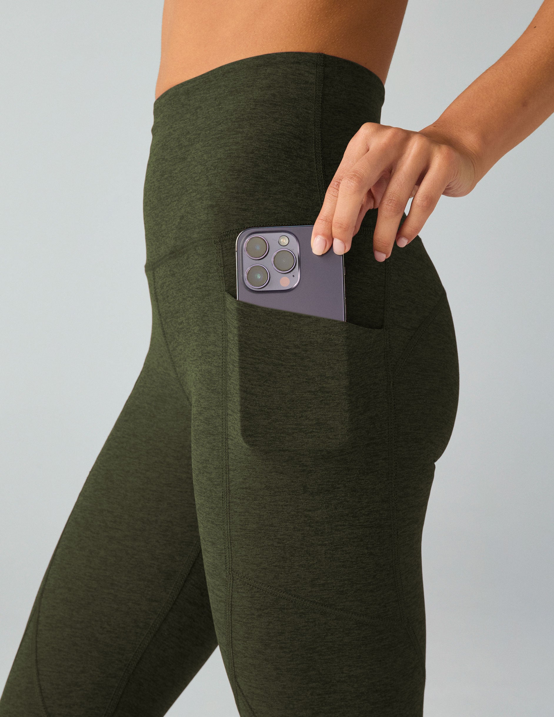 green high-waisted midi leggings with side pockets. 