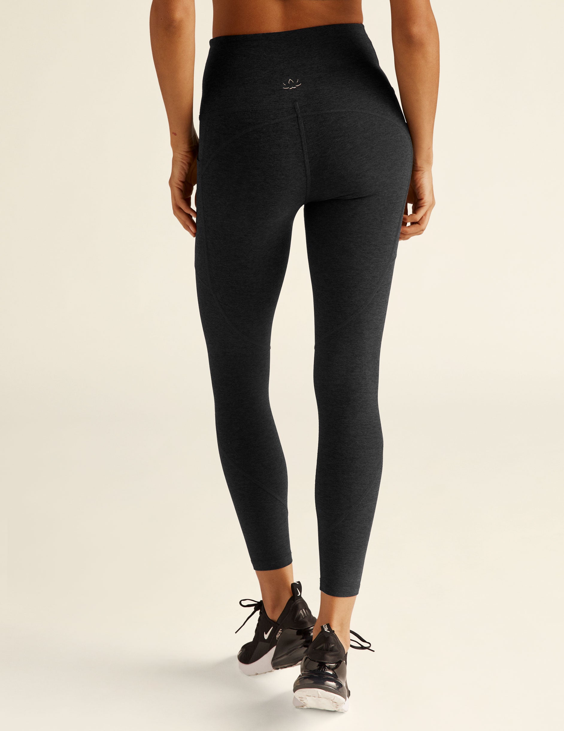 black high-waisted leggings with side pockets. midi length, stops right above ankle. 