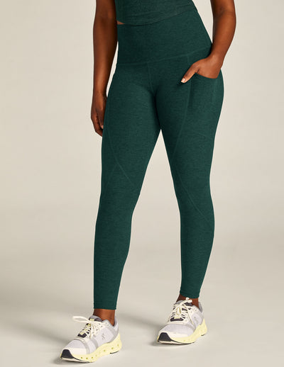green high-waisted midi leggings with a side pocket. 