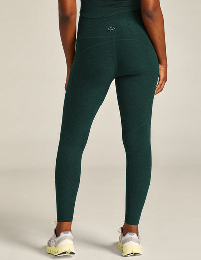 green high-waisted midi leggings with a side pocket. 