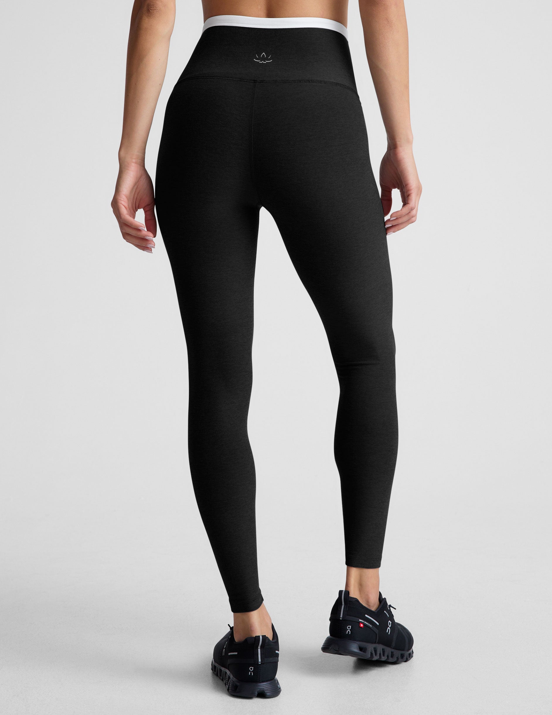 black high-waisted midi length legging with white contrast binding at crossover waistband. 