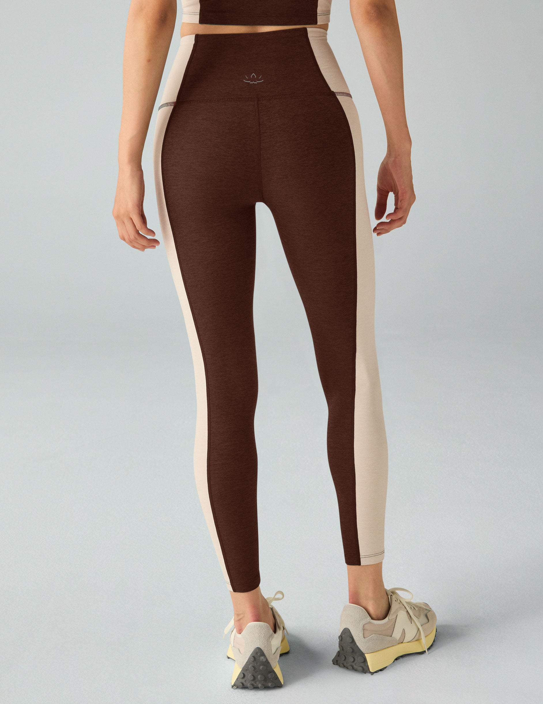 brown high-waisted midi leggings with white lining on the sides. 