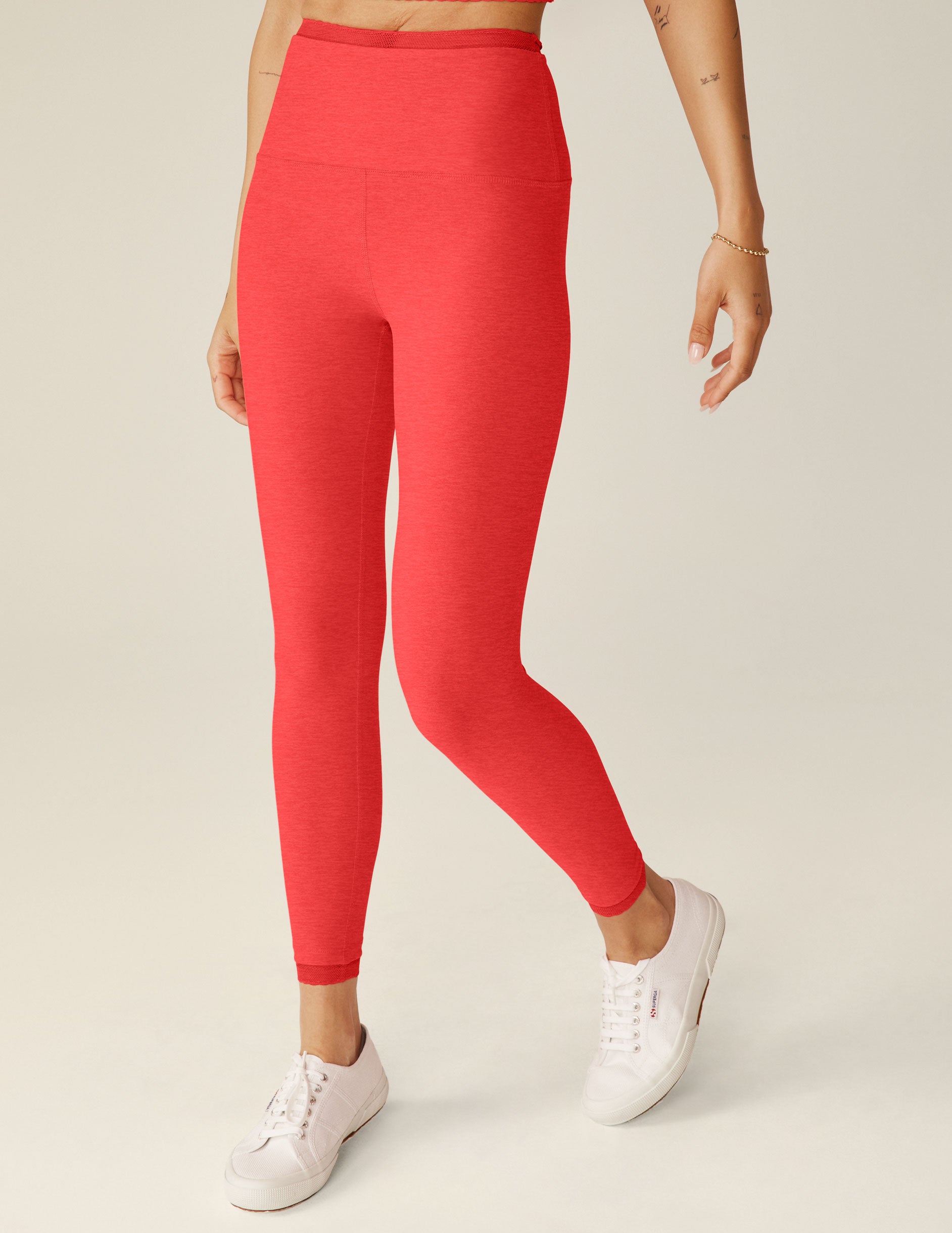 red high-waisted midi leggings with lace trim at the waistband and lace trim at ankles.