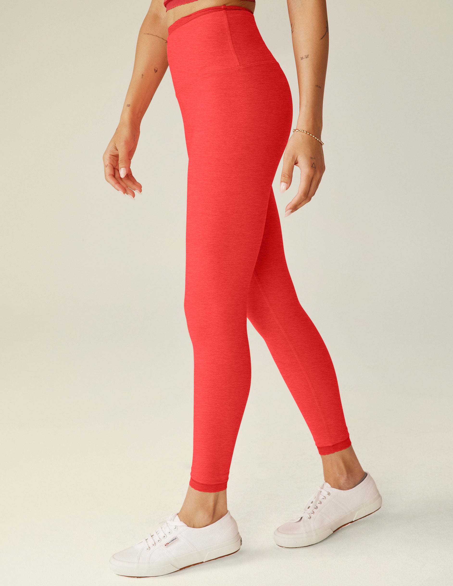 red high-waisted midi leggings with lace trim at the waistband and lace trim at ankles.