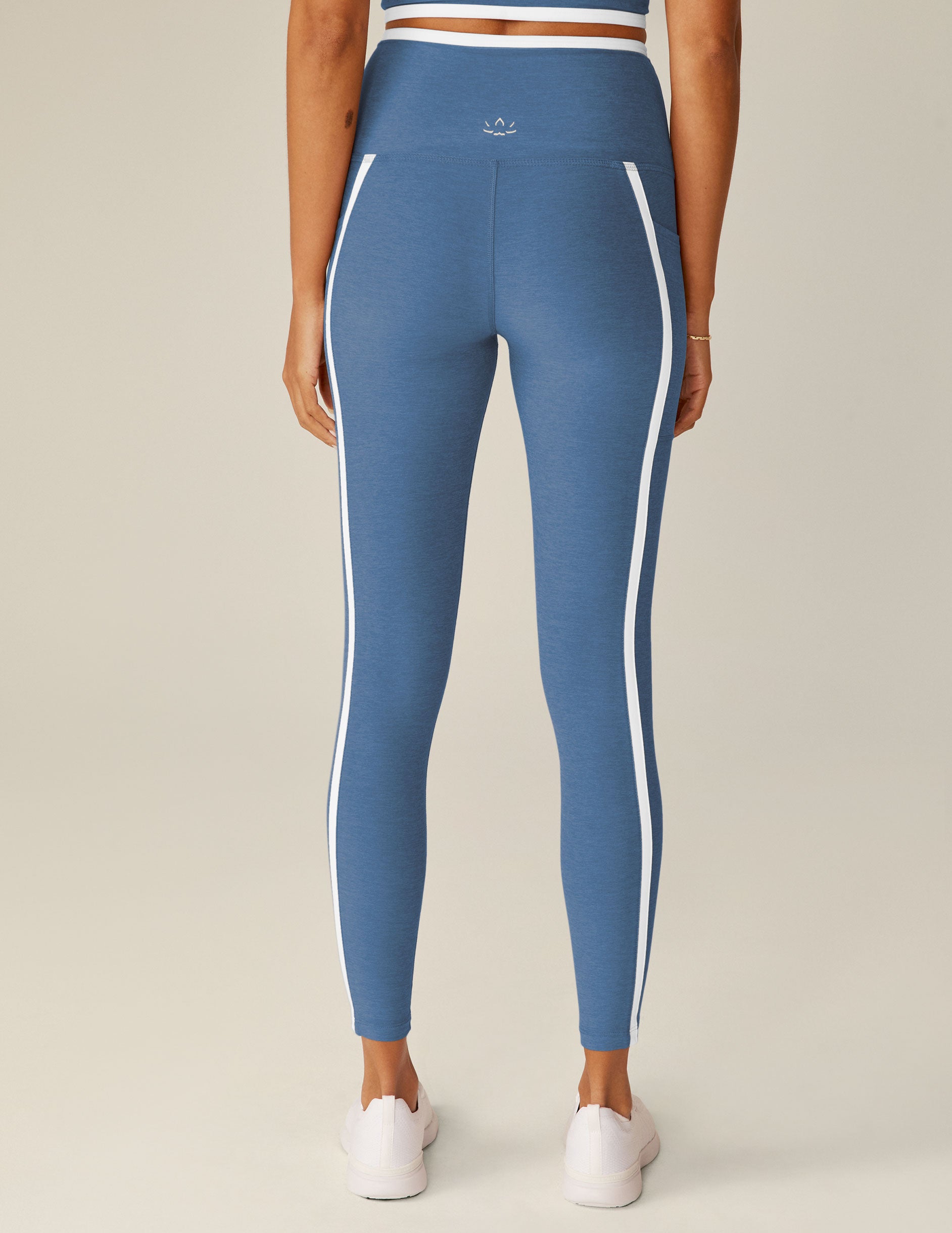 blue high-waisted midi leggings with white lining on waistband and down the sides. 