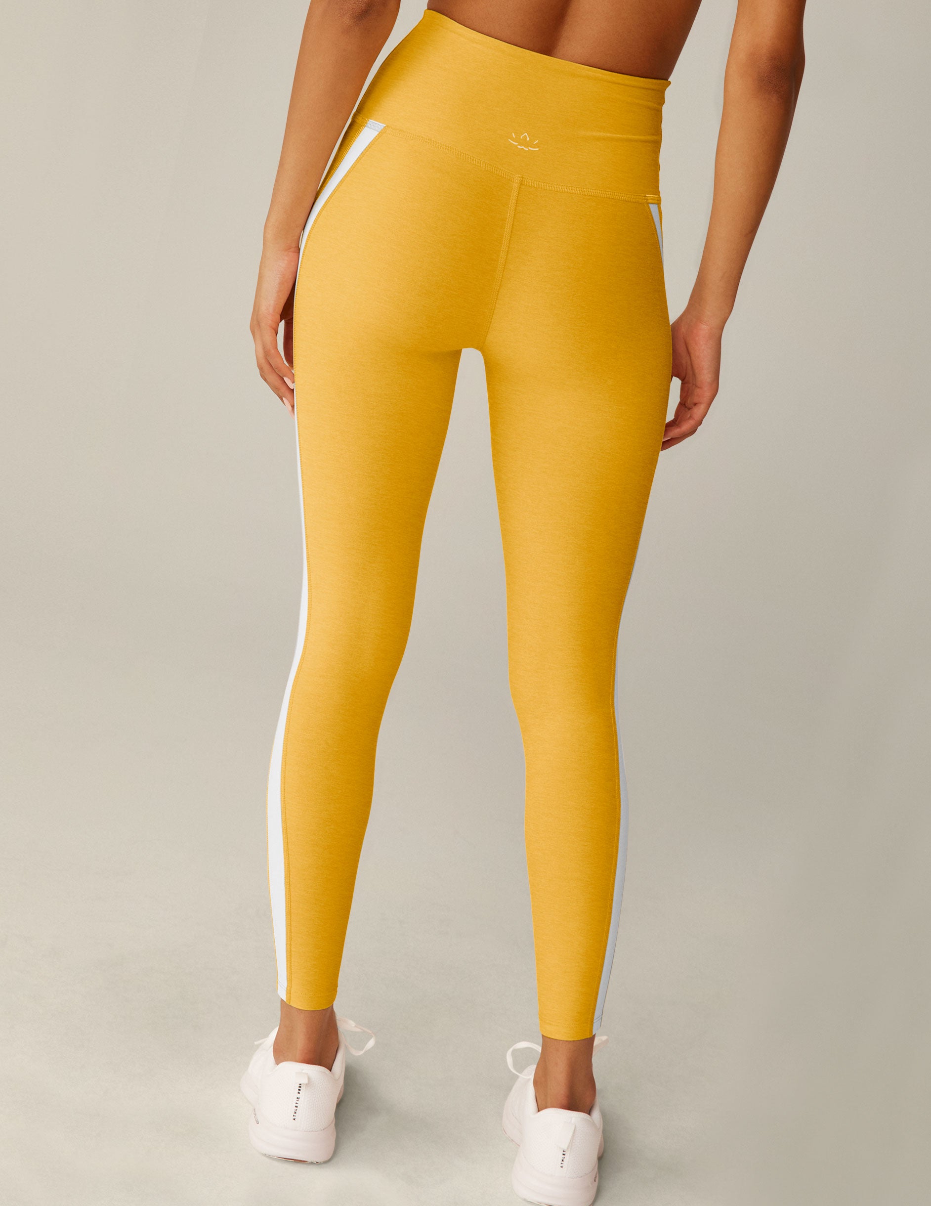 yellow high-waisted midi spacedye leggings with white stripes down the side. 