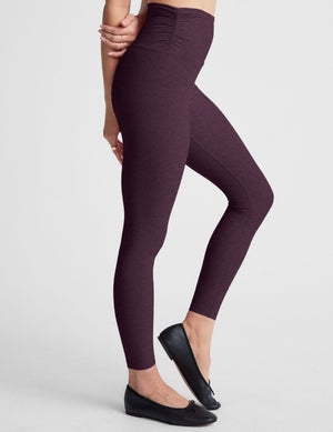 purple high-waisted midi length leggings against a plain background. 