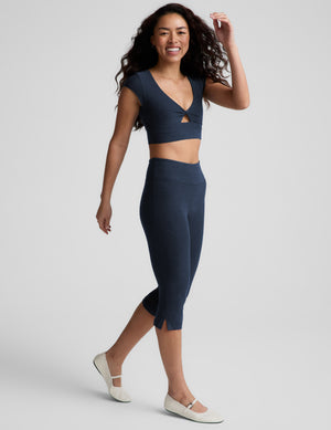 Navy Spacedye Mid-Rise Slit Pedal Pusher Legging on a model, showing the snug mid-calf fit and side slits at the hem.