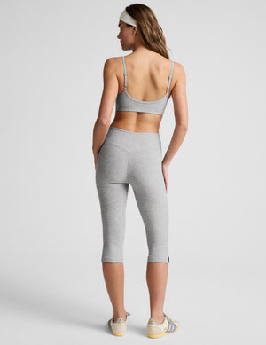 Back view of grey marled Spacedye Mid-Rise Slit Pedal Pusher Leggings with a wide waistband and calf-length side slits.