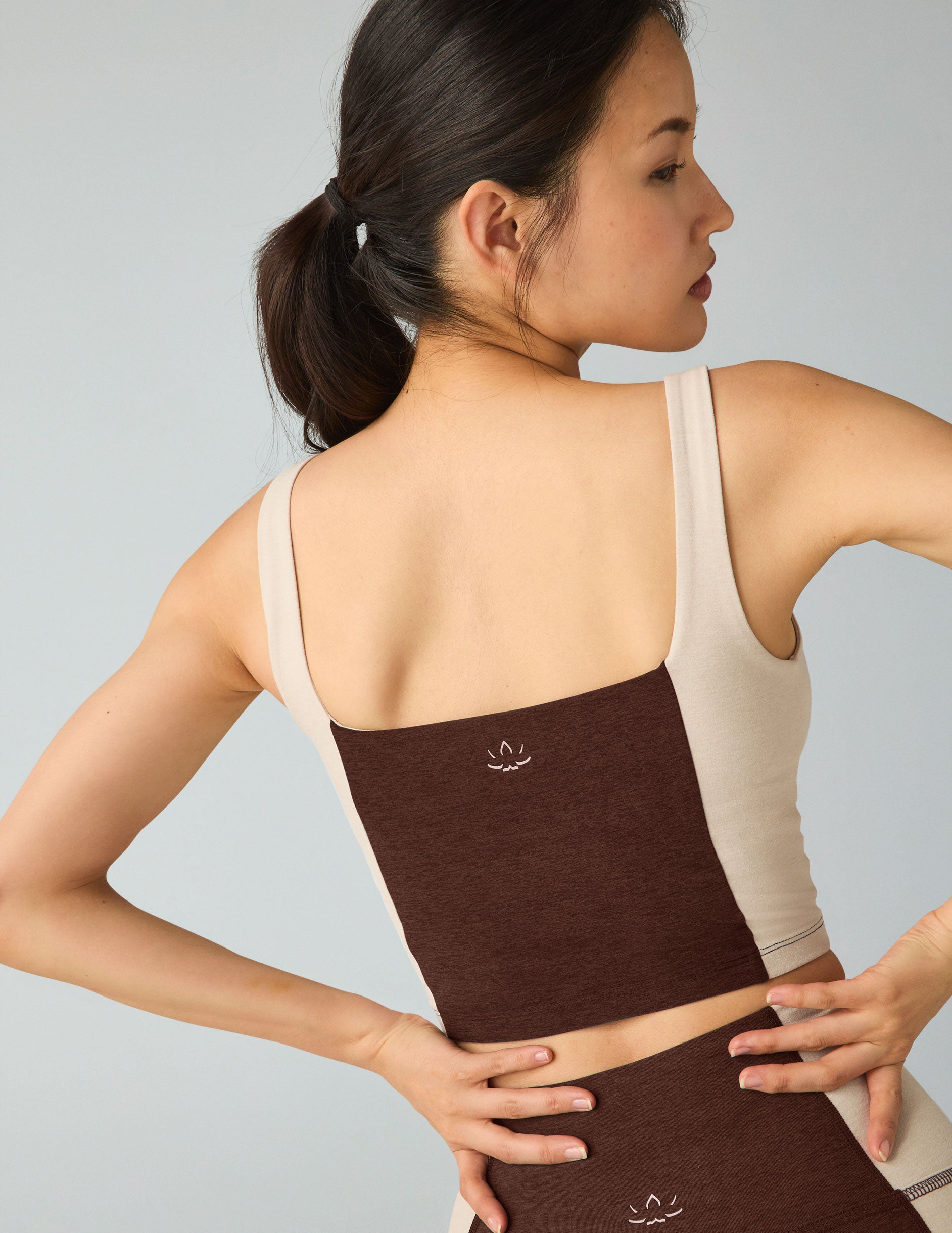 brown square neck cropped tank with white straps and white outlining down the sides. 