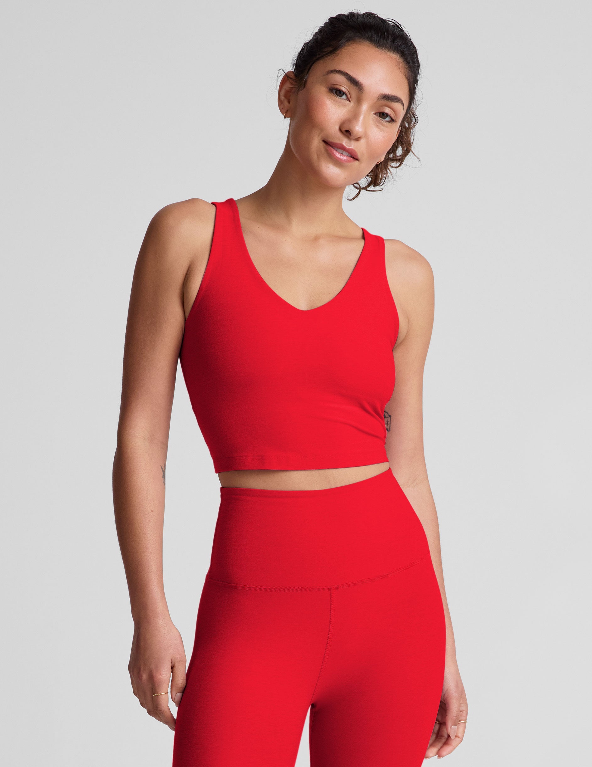 red cropped tank top with a front and back v neckline. 