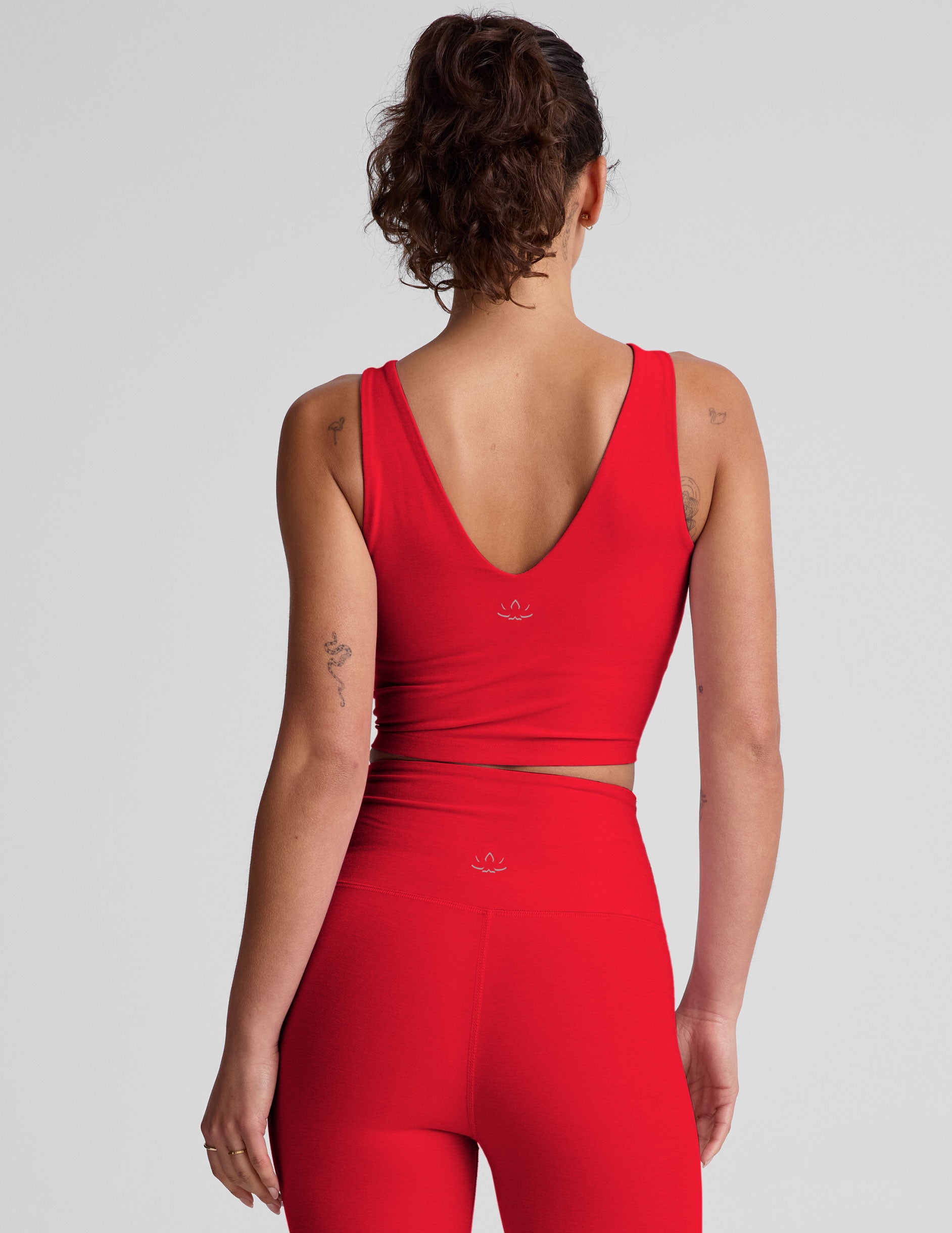 red cropped tank top with a front and back v neckline. 