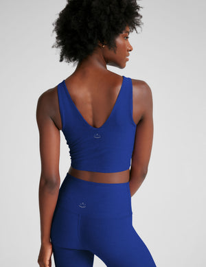 blue cropped tank top with a front and back v neckline. 