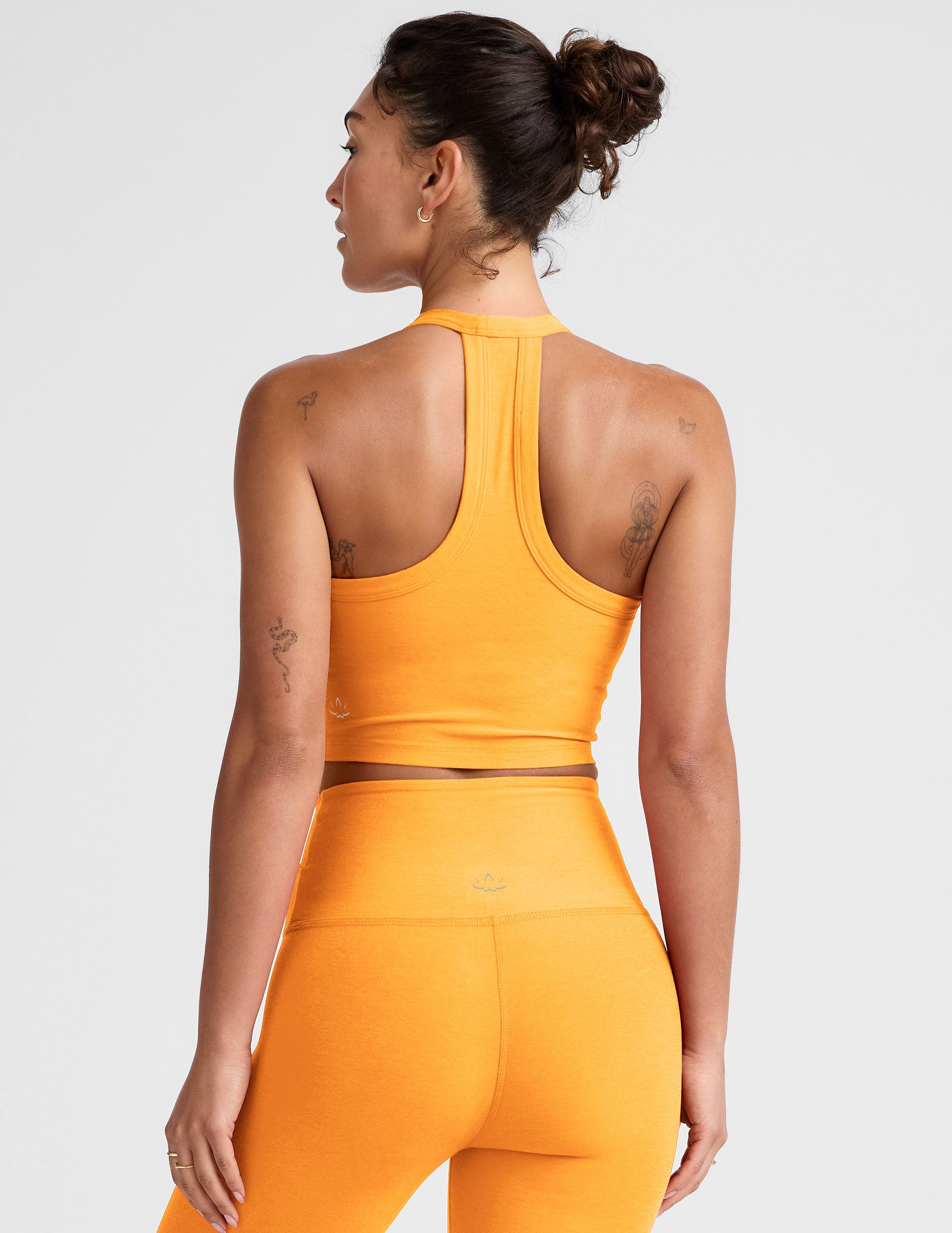 orange v-neck cropped tank with a high racerback. 
