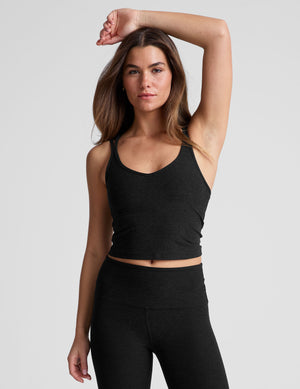 black waist length, V neckline​ tank top with a self shelf bra and criss-cross strap back detail​. 