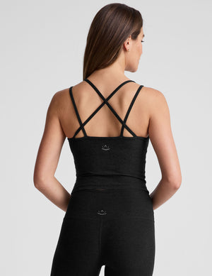 black waist length, V neckline​ tank top with a self shelf bra and criss-cross strap back detail​. 