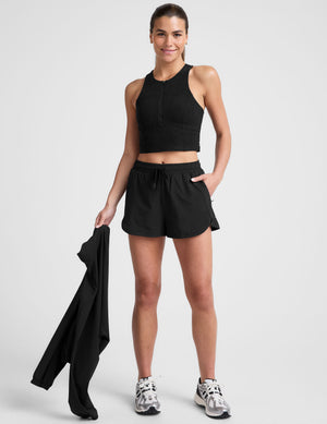 black cropped tank with a high neck with center front zipper. 