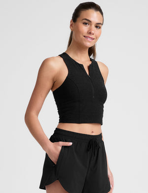 black cropped tank with a high neck with center front zipper. 
