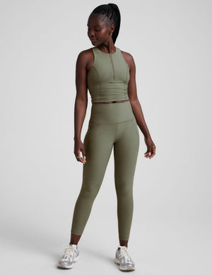 full body image of a green racerback cropped tank with a half zip up detail in front. 