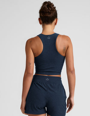 blue cropped tank with a high neck with center front zipper. 