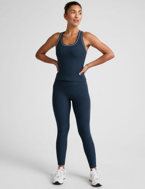 blue midway length racerback tank with white contrast trim. 