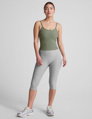 green waist length tank top with adjustable straps. 