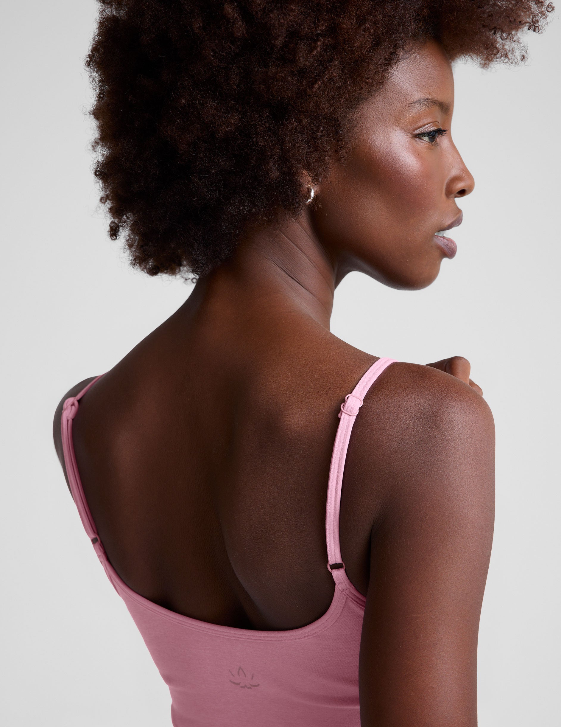 pink midway length tank with adjustable spaghetti straps. 