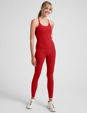 model wearing a red racerback full length tank top against a plain background. 