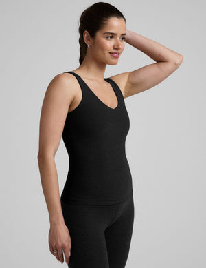 black waist length tank top with a front and back v neckline. 