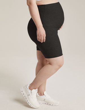 Profile view of Spacedye Cruiser Maternity Biker Short in black marled fabric with a high over-the-belly waistband.