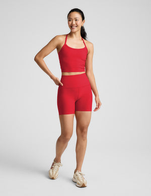 Woman wearing a red cropped tank and 5