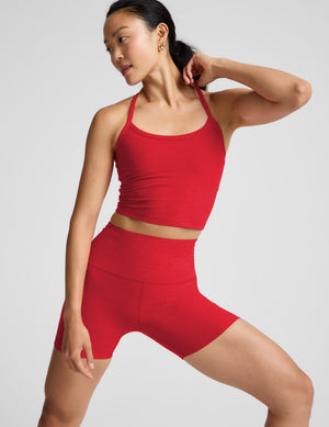 Woman wearing a red cropped tank and 5