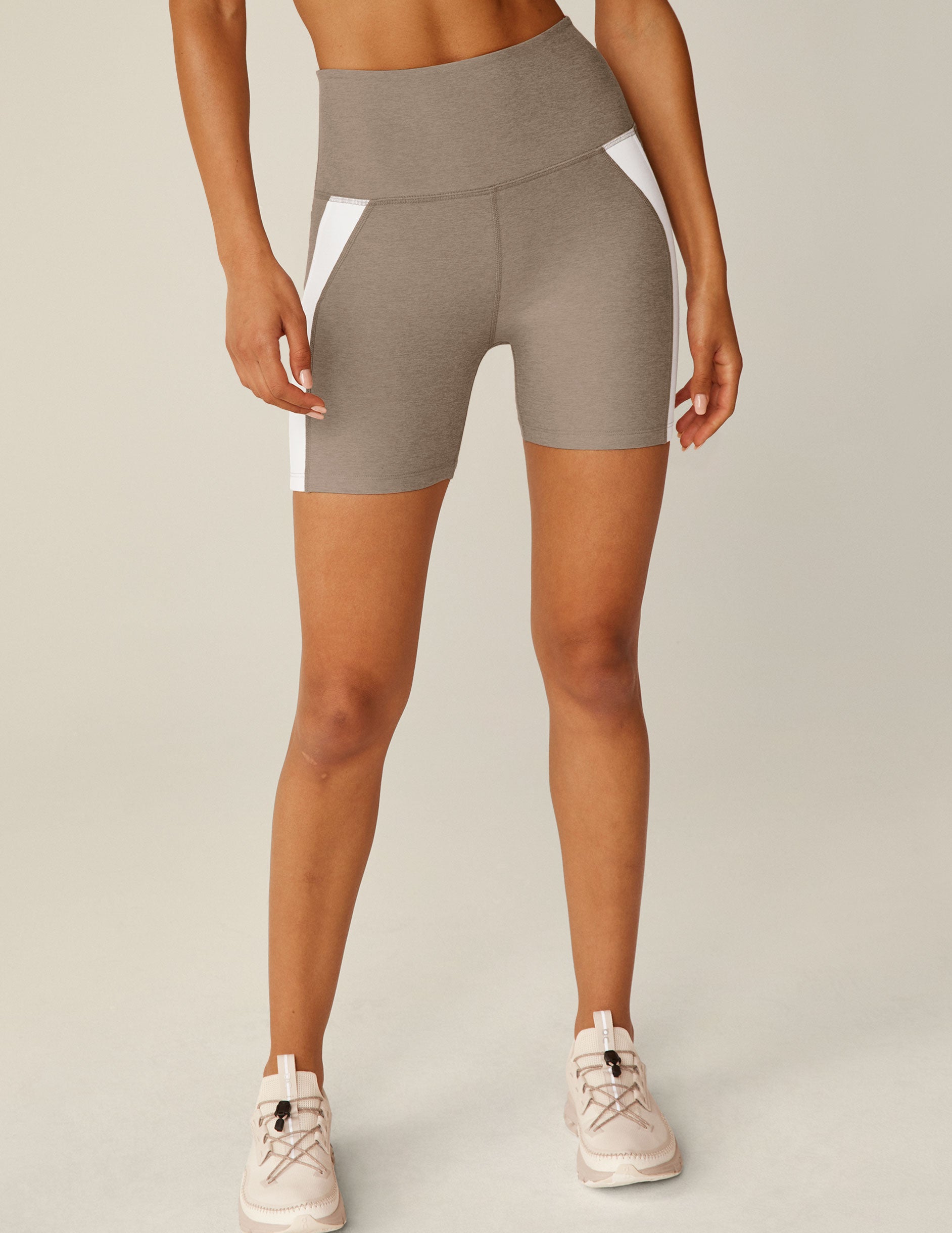 brown high-waisted biker shorts with white lining on the sides. 