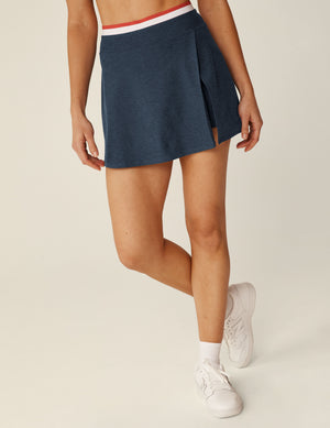 blue spacedye wrap mini skirt with white and red outline along the waistband and a front slit. 